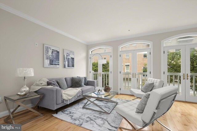 1252 Harbor Island Walk, Baltimore, MD 21230 - living room featuring french doors, ornamental molding, healthy amount of natural light, light wood-style flooring, and baseboards