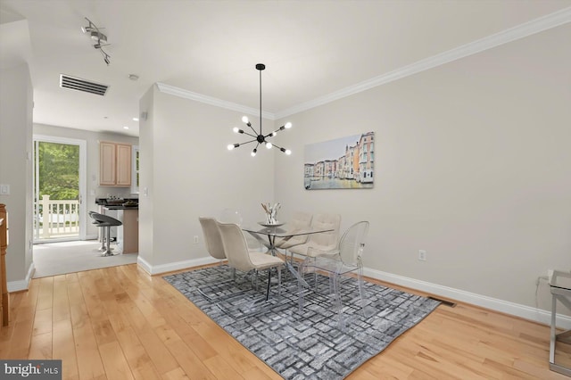 1252 Harbor Island Walk, Baltimore, MD 21230 - dining space featuring light wood-type flooring, a chandelier, ornamental molding, and baseboards