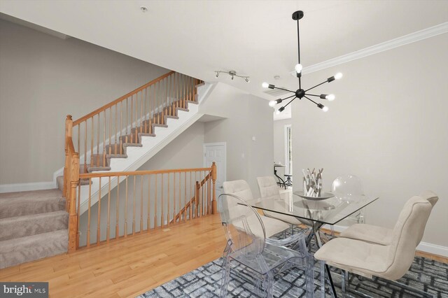 1252 Harbor Island Walk, Baltimore, MD 21230 - dining space featuring wood finished floors, a chandelier, crown molding, baseboards, and stairs