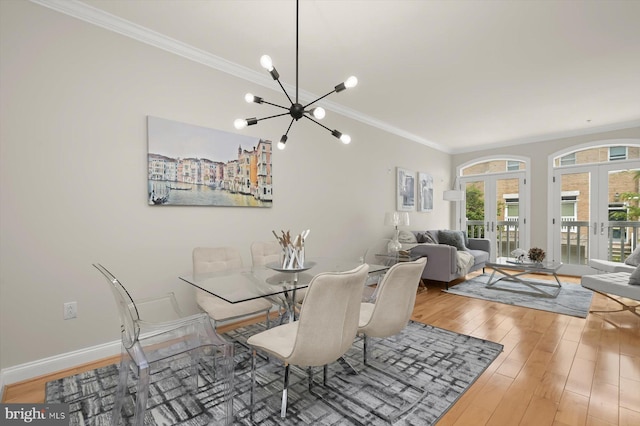 1252 Harbor Island Walk, Baltimore, MD 21230 - dining space with a chandelier, wood finished floors, crown molding, baseboards, and french doors