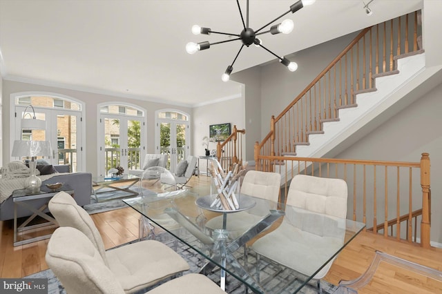 1252 Harbor Island Walk, Baltimore, MD 21230 - dining space featuring a chandelier, wood finished floors, ornamental molding, stairway, and french doors