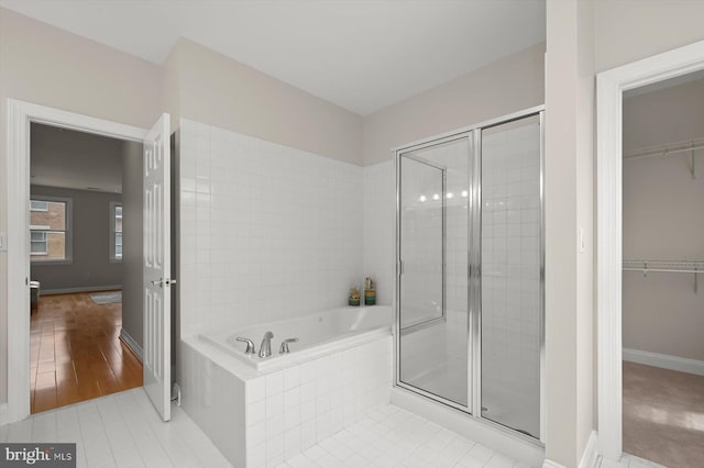 1252 Harbor Island Walk, Baltimore, MD 21230 - bathroom with a stall shower, a walk in closet, a garden tub, and tile patterned floors