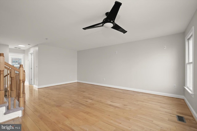 1252 Harbor Island Walk, Baltimore, MD 21230 - unfurnished living room featuring ceiling fan, light wood-style flooring, baseboards, and stairs