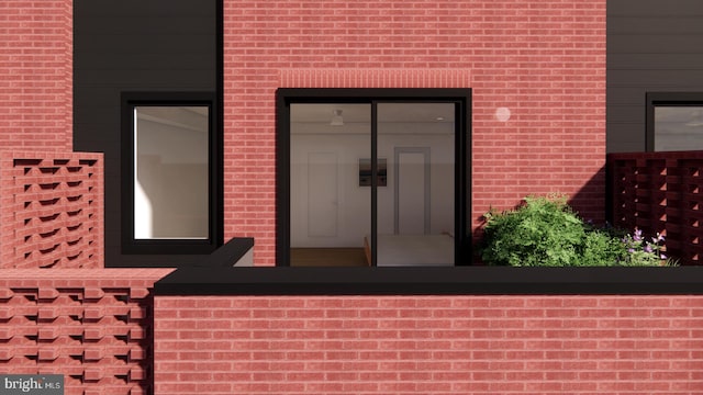 property entrance featuring brick siding