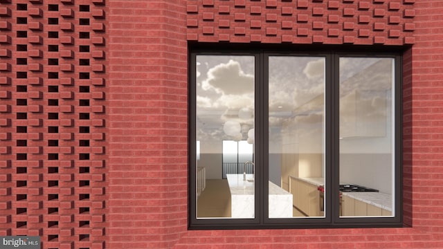 doorway to property featuring brick siding