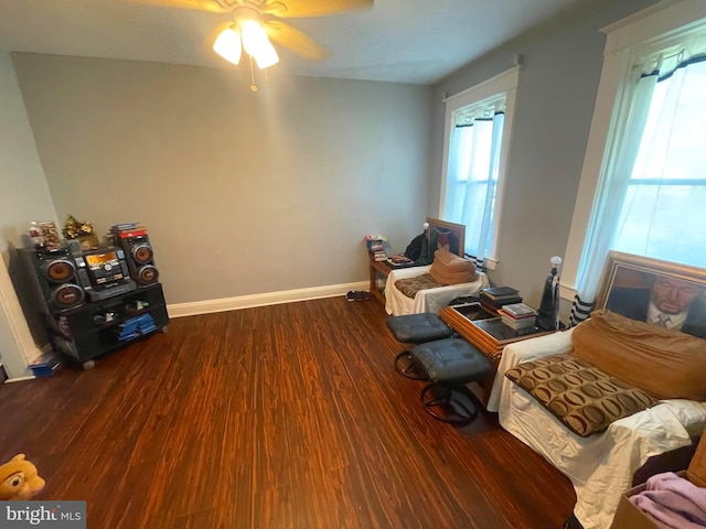 sitting room with wood finished floors, ceiling fan, and baseboards