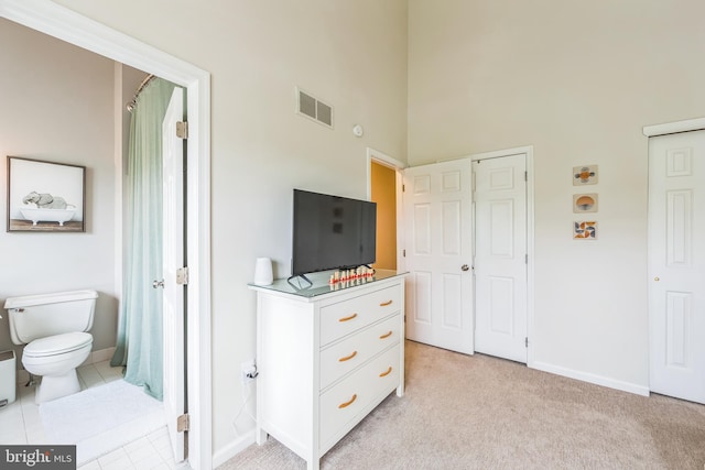 517 Bullock Unit 13, Conshohocken, PA 19428 - bedroom with a high ceiling, baseboards, multiple closets, and light colored carpet