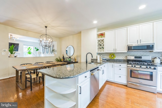 517 Bullock Unit 13, Conshohocken, PA 19428 - kitchen with open shelves, stainless steel appliances, a sink, a peninsula, and white cabinetry