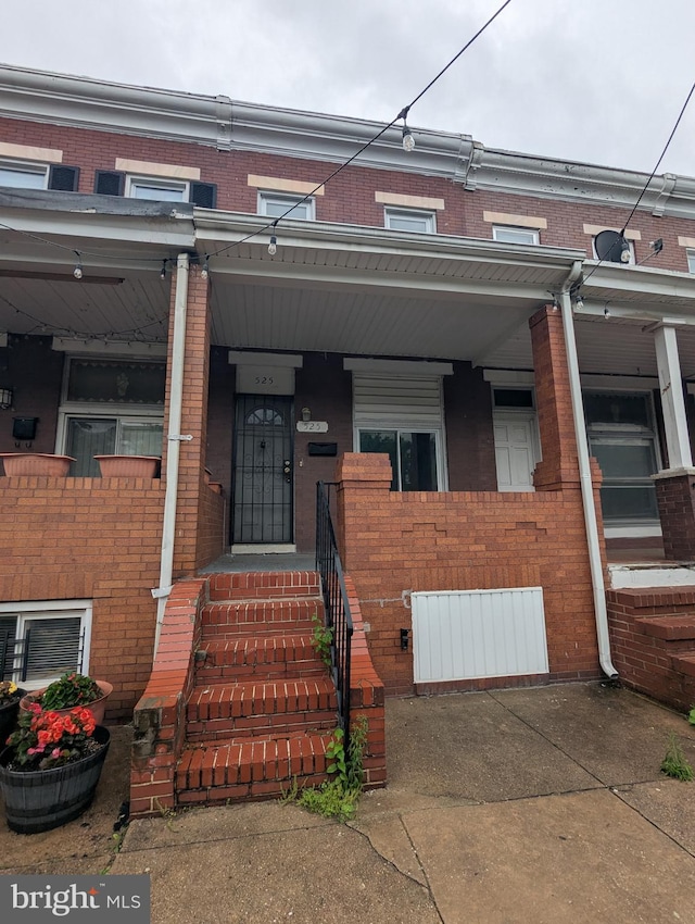 525 N Robinson St, Baltimore, MD 21205 - view of property featuring brick siding and covered porch