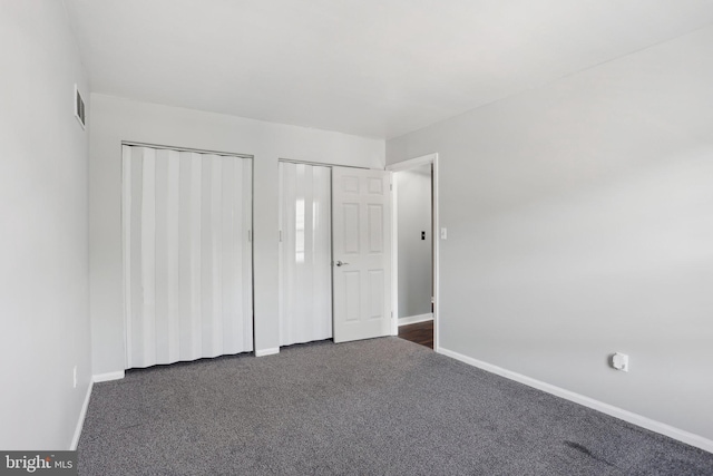 835 Sabina Cir, Bear, DE 19701 - unfurnished bedroom with baseboards, dark carpet, and multiple closets
