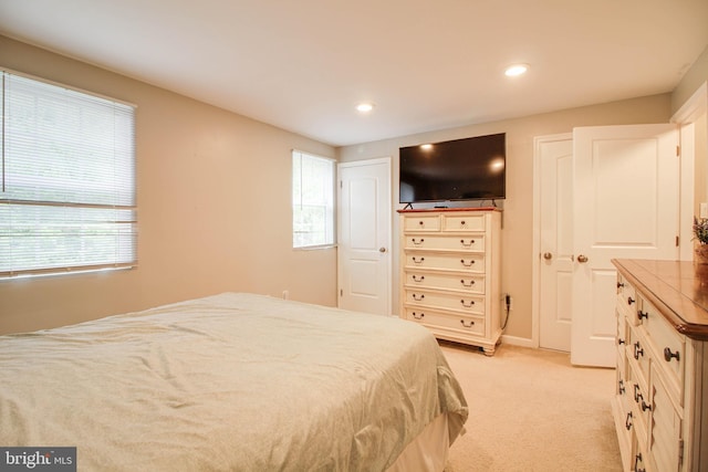 bedroom featuring light colored carpet and recessed lighting