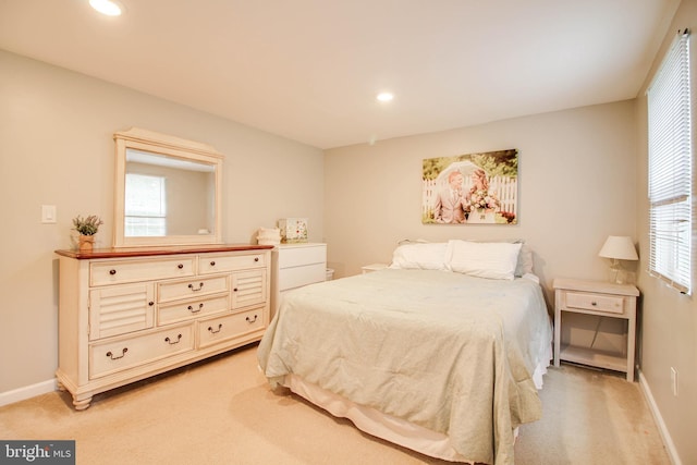 bedroom featuring light colored carpet, multiple windows, baseboards, and recessed lighting
