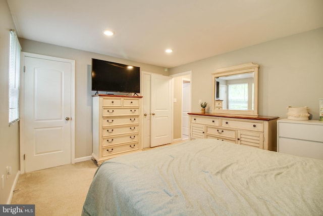 bedroom featuring light colored carpet, recessed lighting, and baseboards