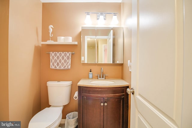 half bath featuring toilet and vanity
