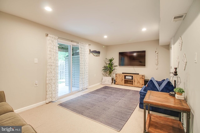 living room featuring carpet, baseboards, and recessed lighting