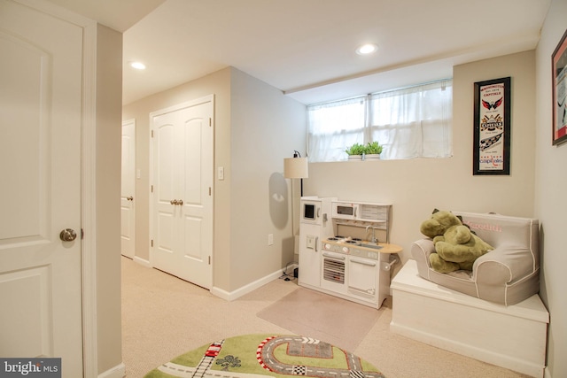 playroom featuring light carpet, recessed lighting, and baseboards