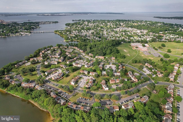aerial view of property's location with a large body of water and nearby suburban area
