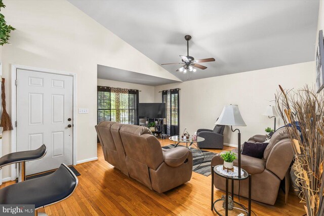 309 6th St, Colonial Beach, VA 22443 - living area featuring wood finished floors, a ceiling fan, baseboards, and high vaulted ceiling