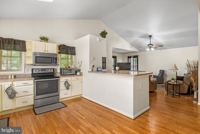309 6th St, Colonial Beach, VA 22443 - kitchen with appliances with stainless steel finishes, vaulted ceiling, light wood-style floors, open floor plan, and plenty of natural light