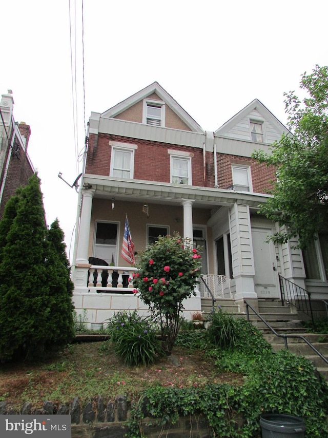 view of property featuring covered porch