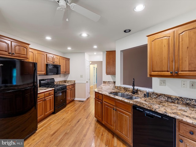 1412 Magruder Ct, Winchester, VA 22601 - kitchen with black appliances, a sink, light wood-type flooring, ceiling fan, and stone countertops