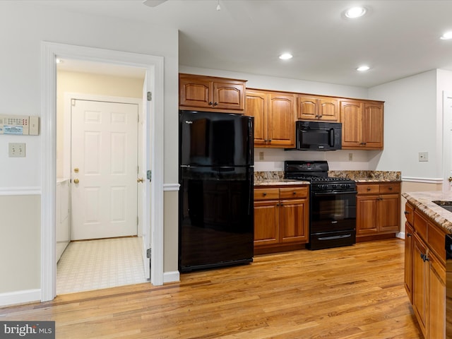 1412 Magruder Ct, Winchester, VA 22601 - kitchen with black appliances, light wood finished floors, brown cabinetry, and recessed lighting