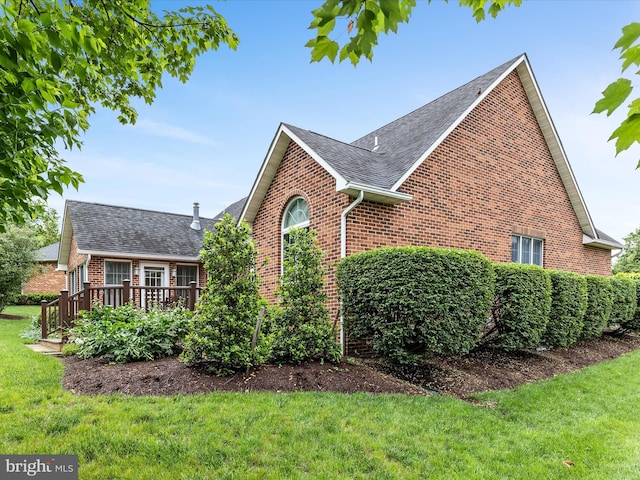1412 Magruder Ct, Winchester, VA 22601 - view of property exterior with brick siding, a shingled roof, a lawn, and a wooden deck
