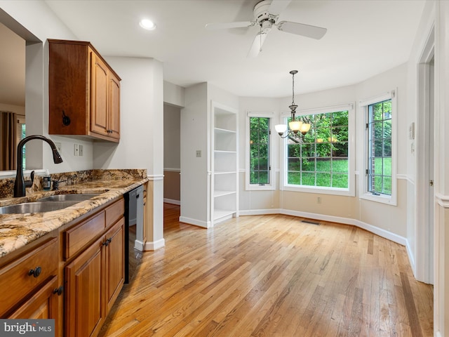 1412 Magruder Ct, Winchester, VA 22601 - kitchen with a sink, dishwashing machine, light wood-style floors, baseboards, and brown cabinetry