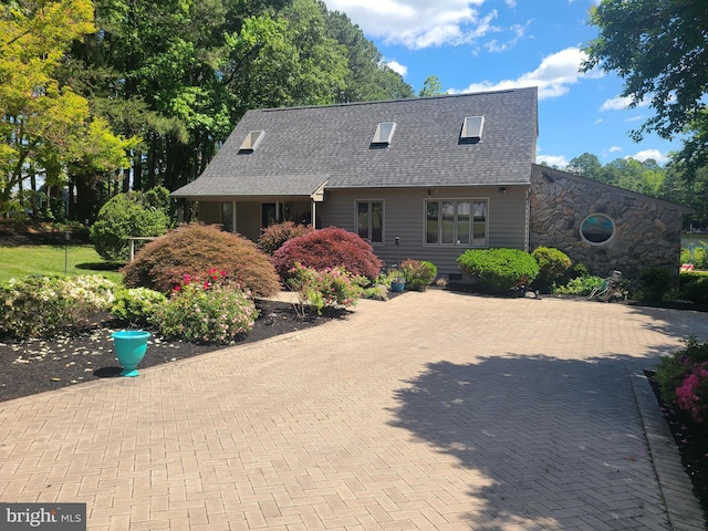 cape cod-style house with a shingled roof