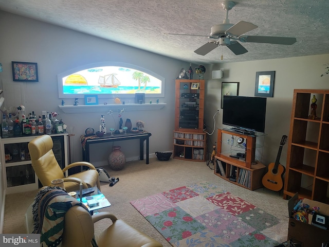 living room featuring carpet floors, a ceiling fan, and a textured ceiling