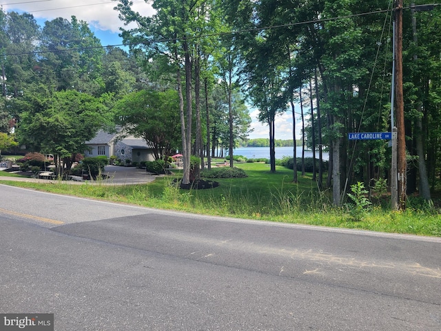 view of asphalt road featuring a water view