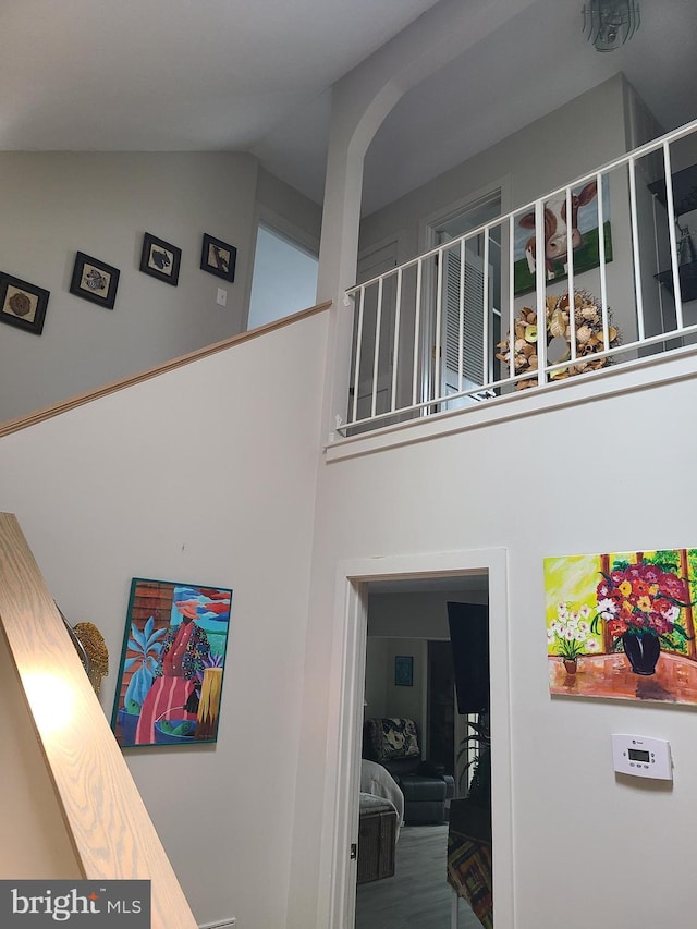 staircase featuring high vaulted ceiling