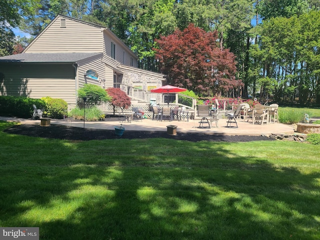 back of house with a yard and a patio area
