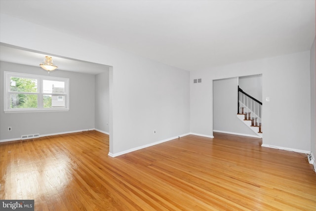 2518 Reynolds Ave, Claymont, DE 19703 - spare room with stairway, light wood finished floors, and baseboards