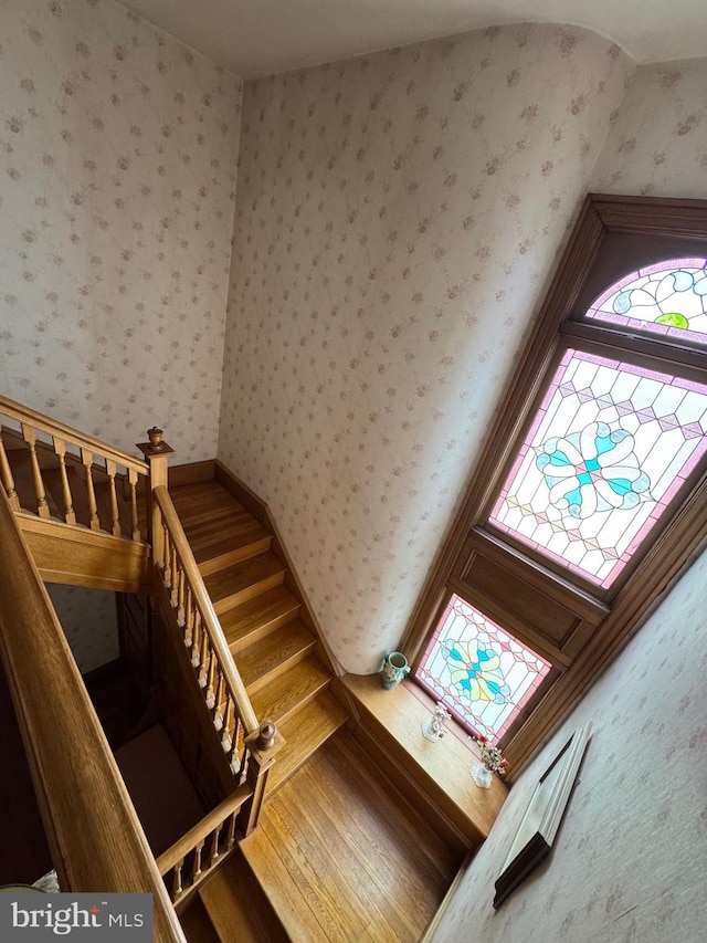 stairway with wallpapered walls