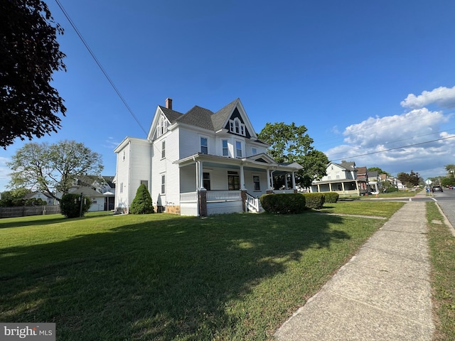 view of home's exterior with covered porch and a chimney