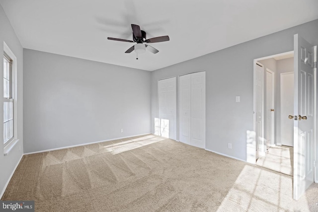 312 E Cornell Dr, Sterling, VA 20164 - unfurnished bedroom featuring multiple closets, carpet flooring, baseboards, and ceiling fan