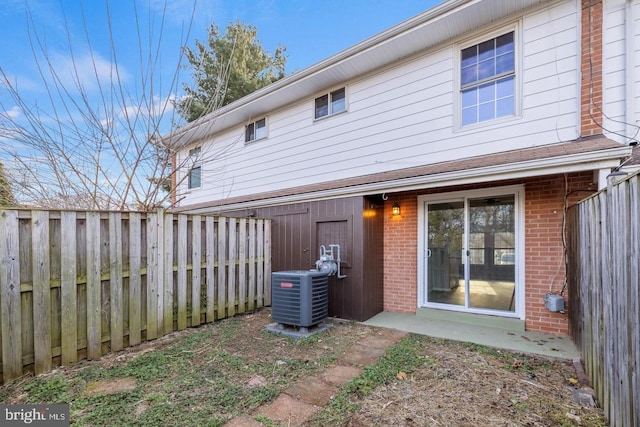 312 E Cornell Dr, Sterling, VA 20164 - back of house with brick siding, central AC unit, and a fenced backyard