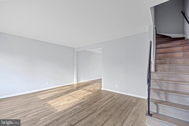 312 E Cornell Dr, Sterling, VA 20164 - unfurnished living room featuring wood finished floors, stairs, and baseboards