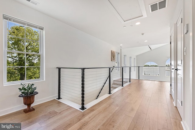 hall featuring attic access, light wood-type flooring, an upstairs landing, baseboards, and recessed lighting