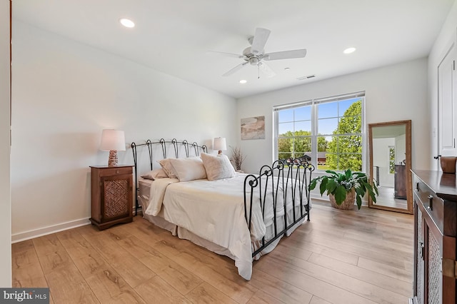 bedroom with light wood finished floors, recessed lighting, a ceiling fan, and baseboards