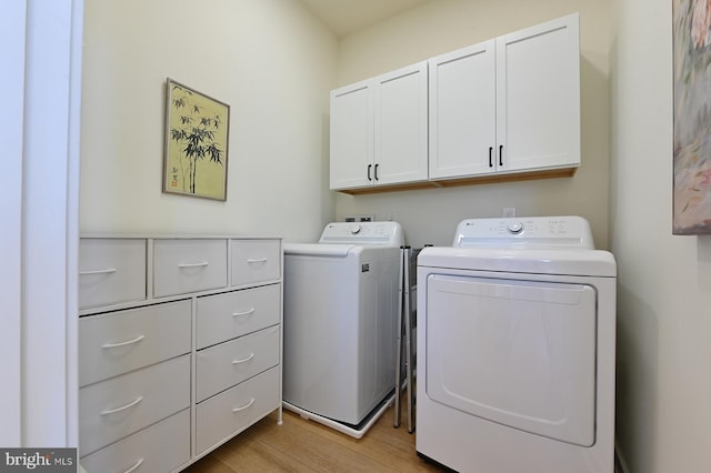 laundry room featuring cabinet space, independent washer and dryer, and light wood finished floors