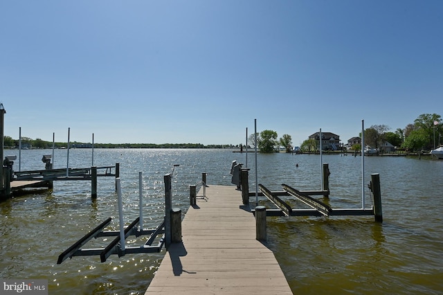 dock area with a water view and boat lift