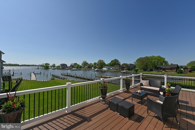 wooden deck featuring boat lift, a yard, a water view, a dock, and an outdoor living space