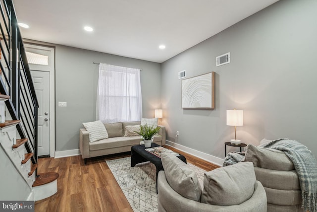 living room with stairway, baseboards, wood finished floors, and recessed lighting