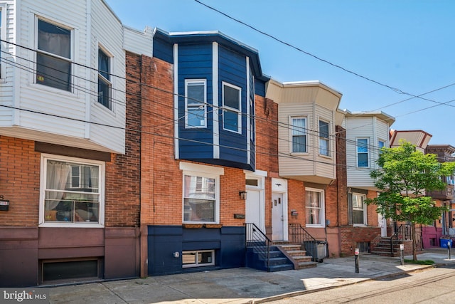 townhome / multi-family property with brick siding