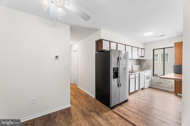 210 Trimper Ave Unit 8, Ocean City, MD 21842 - kitchen with stainless steel refrigerator with ice dispenser, white range with electric cooktop, backsplash, wood finished floors, and ceiling fan