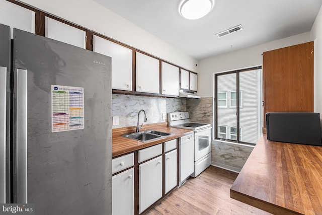 210 Trimper Ave Unit 8, Ocean City, MD 21842 - kitchen featuring white appliances, a sink, under cabinet range hood, light wood-style flooring, and white cabinets