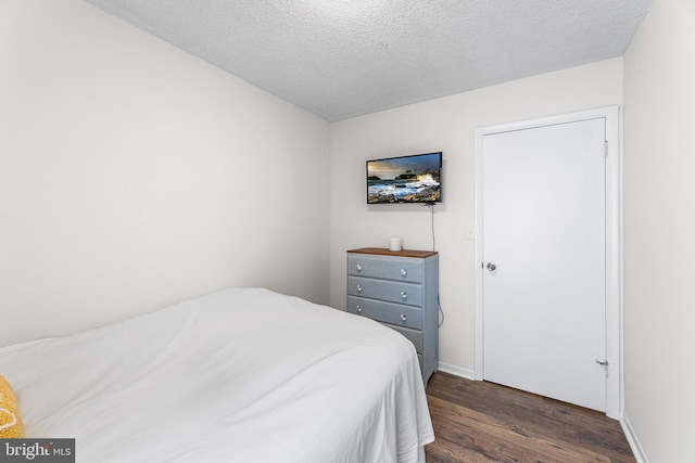 210 Trimper Ave Unit 8, Ocean City, MD 21842 - bedroom with dark wood finished floors, baseboards, and a textured ceiling