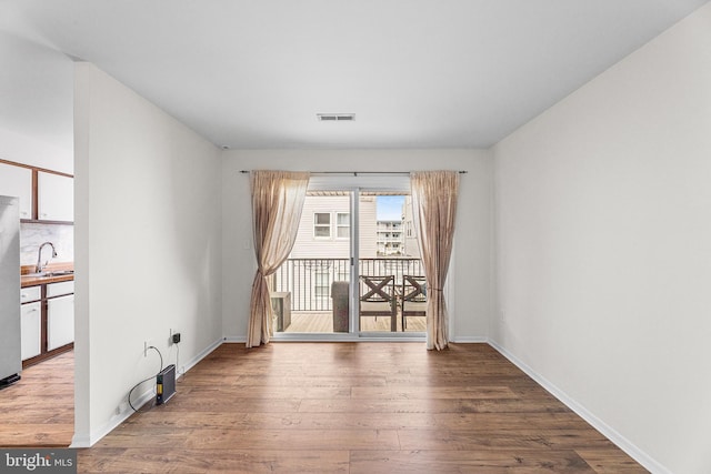 210 Trimper Ave Unit 8, Ocean City, MD 21842 - unfurnished room with a sink, wood finished floors, and baseboards